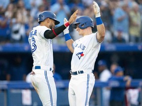 Jul 28, 2022; Toronto, Ontario, CAN; Toronto Blue Jays third baseman Matt Chapman (26) hits a two run home run and celebrates with Toronto Blue Jays left fielder Lourdes Gurriel Jr. (13) against the Detroit Tigers during the fourth inning at Rogers Centre.