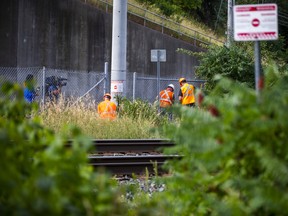 An unfenced path leading to train tracks as work crews are on the scene the morning after a four-year-old girl was struck and killed by a GO Train near Lolita Gardens and Silver Creek Blvd. in Mississauga, Ont. on Wednesday, July 27, 2022.