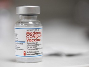A vial of the Moderna COVID-19 vaccine is displayed on a counter at a pharmacy in Portland, Ore. Dec. 27, 2021.
