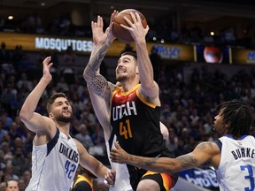 Former Utah Jazz forward Juancho Hernangomez (41) goes up to shoot as Dallas Mavericks' Maxi Kleber (42) and Trey Burke (3) defend in the first half of Game 2 of an NBA basketball first-round playoff series, on April 18, 2022, in Dallas. The Toronto Raptors have signed Hernangomez. Terms were not disclosed, but ESPN reported the deal is for one year.