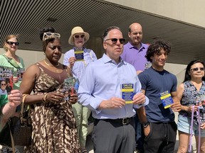 Blake Acton (light blue shirt, grey pants), surrounded by a few supporters, officially announced his run for Toronto mayor on the steps to Nathan Phillips Square on Saturday, July 23, 2022.