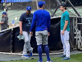 Mariners reliever Ryan Borucki (right) chats pre-game yesterday at T-Mobile Field in Seattle with a couple of former Blue Jays teammates in outfielder George Springer and bench coach John Schneider.