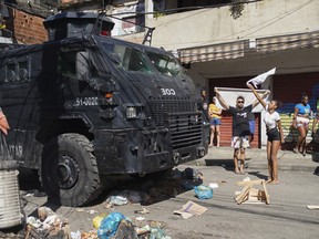 Residents of the Complexo do Alemao favela demonstrate during a police raid in Rio de Janeiro, Brazil, on July 21, 2022.