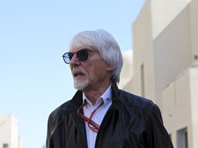 Former Formula One boss Bernie Ecclestone walks in the paddock during the first free practice at the Yas Marina racetrack in Abu Dhabi, United Arab Emirates, Friday Nov. 23, 2018.