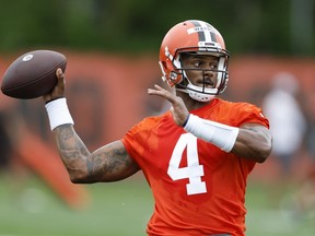 FILE - Cleveland Browns quarterback Deshaun Watson takes part in drills at the NFL football team's practice facility Tuesday, June 14, 2022, in Berea, Ohio. Watson reported to his first training camp with the Browns on Friday, July 22, 2022, still not knowing how long he'll be their starting quarterback.