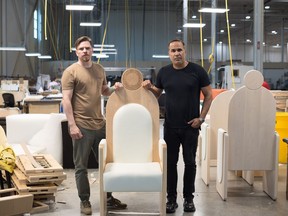 Senior designer Rafael Studart, left, and Quality and Company president Frank Caruso pose with a chair made for Pope Francis to sit in while he makes stops in Canada at their studio in Vaughan, Ont., on Friday, July 15, 2022.