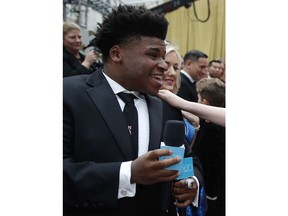 Jerry Harris talks to an actress on the red carpet at the Oscars at the Dolby Theatre in Los Angeles on Feb. 9, 2020.