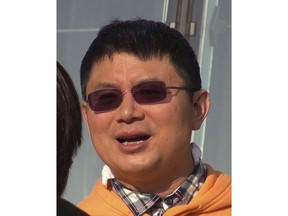 FILE - Xiao Jianhua, a Chinese-born Canadian billionaire talks to reporters outside the International Finance Centre in Hong Kong in Dec., 2013. Xiao is being put on trial in China, Canada's government said Monday, July 4, 2022, five years after he vanished from Hong Kong during an anti-corruption crackdown. (Next Magazine via AP, File)