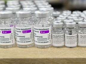Vials of both Pfizer-BioNTech and Oxford-AstraZeneca COVID-19 vaccines sit empty on the counter at the Junction Chemist Pharmacy, in Toronto on June 18, 2021.