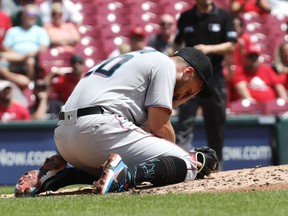 Miami Marlins starting pitcher Daniel Castano reacts on the mound after being hit by a line drive from Cincinnati Reds designated hitter Donovan Solano (not pictured) during the first inning at Great American Ball Park in Cincinnati, Ohio, July 28, 2022.