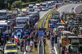 Farmers gather with their vehicles next to a border sign between Germany and the Netherlands during a protest on the A1 motorway near Rijssen against the Dutch government's nitrogen plans on June 29, 2022.