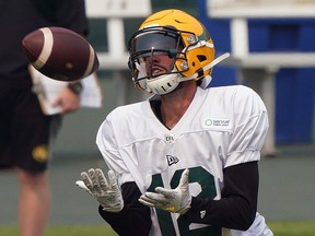 Wide receiver Mike Jones prepares to make a reception at the Edmonton Elks training camp in Edmonton on Thursday July 15, 2021.