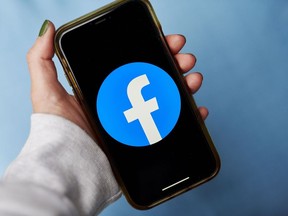 The logo for Facebook is displayed on a smartphone.