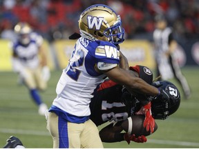 Winnipeg Blue Bombers defensive back Tyquwan Glass (#22) tackles Ottawa Redblacks wide receiver Justin Hardy (#18) during first half CFL action at TD Place Stadium in Ottawa on Friday June 17, 2022.