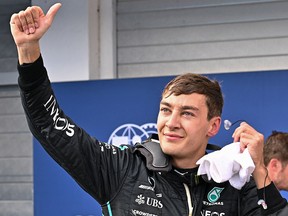 George Russell gestures after winning the pole position during the qualifying session ahead of the Formula One Hungarian Grand Prix at the Hungaroring in Mogyorod near Budapest, Hungary, on July 30, 2022.
