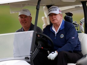 U.S. President Donald Trump drives a golf cart at the Trump National Golf Club in Sterling, Virginia, U.S., November 22, 2020.