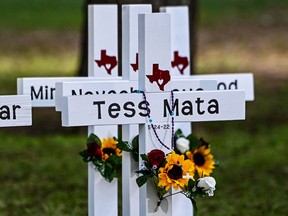 Crosses adorn a makeshift memorial for the shooting victims at Robb Elementary School in Uvalde, Texas, on May 26, 2022.