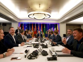 Premiers mingle during a photo op while at the summer meeting of the Canada's Premiers at the Fairmont Empress in Victoria, Monday, July 11, 2022.