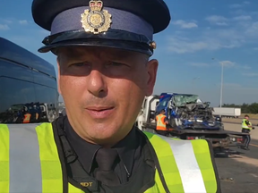 OPP Sgt. Kerry Schmidt at the scene of a fatal crash on Hwy. 401 in Mississauga July 19, 2022 involving an SUV (in background) and transport truck it rear-ended.