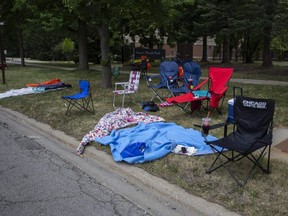 Chairs and blankets are left abandoned after a shooting at a Fourth of July parade in Highland Park, Ill., Monday, July 4, 2022.