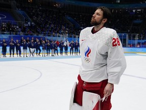 Russian Olympic Committee goalkeeper Ivan Fedotov (28) skates across the ice to receive his silver medal after Finland defeated Russian Olympic Committee in the men's gold medal hockey game at the 2022 Winter Olympics, Sunday, Feb. 20, 2022, in Beijing.