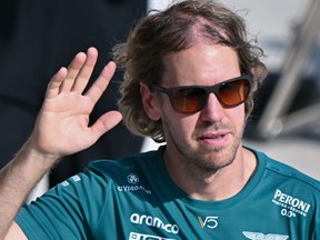 Aston Martin's German driver Sebastian Vettel waves to fans during the Pit Lane Walk ahead of the Formula One Hungarian Grand Prix at the Hungaroring in Budapest on July 28, 2022.