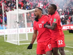 Canada's Cyle Larin (17) celebrates his goal with Richie Laryea against Jamaica during first half CONCACAF World Cup soccer qualifying action in Toronto on Sunday, March 27, 2022.&ampnbsp;Canada will get a taste of World Cup opposition in September with games in Europe against Qatar and Uruguay ahead of the men's soccer showcase in Qatar in November.