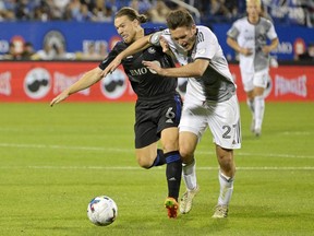 Jul 16, 2022; Montreal, Quebec, CAN; CF Montreal midfielder Samuel Piette (6) takes the ball away from Toronto FC defender Shane O'Neill (27) during the second half at Stade Saputo.