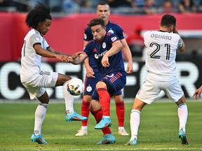 Jul 13, 2022; Chicago, Illinois, USA; Toronto FC forward Jayden Nelson (11) and Chicago Fire FC midfielder Xherdan Shaqiri (10) battle for control of the ball in the first half at Soldier Field.