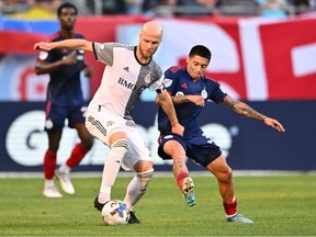 Toronto FC midfielder Michael Bradley and Chicago Fire FC midfielder Federico Navarro battle for control of the ball in the first half at Soldier Field.