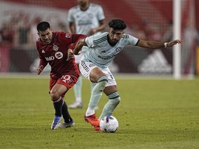 Jun 25, 2022; Toronto, Ontario, CAN; Atlanta United FC midfielder Marcelino Moreno (10) battles with Toronto FC midfielder Alejandro Pozuelo (10) for the ball during the second half at BMO Field.