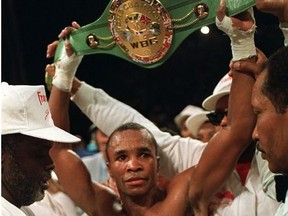 Sugar Ray Leonard holds up the middleweight championship belt after defeating Marvin Hagler in a split decision to win the title in Las Vegas, Nev., April 6, 1987.