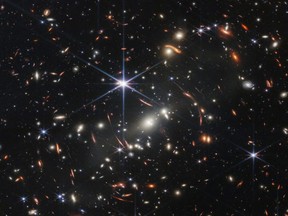 The first full-colour image from NASA's James Webb Space Telescope, a revolutionary apparatus designed to peer through the cosmos to the dawn of the universe, shows the galaxy cluster SMACS 0723, known as Webb?s First Deep Field, in a composite made from images at different wavelengths  taken with a Near-Infrared Camera and released July 11, 2022.