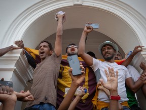 Protestors shout slogans after taking control of the Prime Minister’s office compound during a protest on July 13, 2022 in Colombo, Sri Lanka.