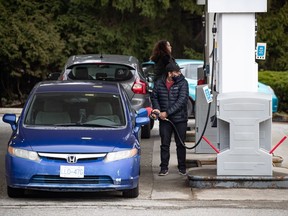 People fuel up their vehicles at a Shell gas station, in Burnaby, B.C., on Wednesday, March 2, 2022.