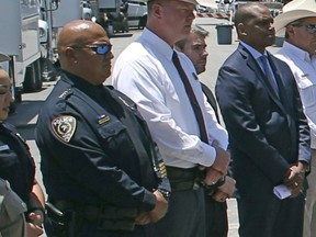 Uvalde School Police Chief Pete Arredondo, second from left, stands during a news conference outside of the Robb Elementary school in Uvalde, Texas, May 26, 2022.