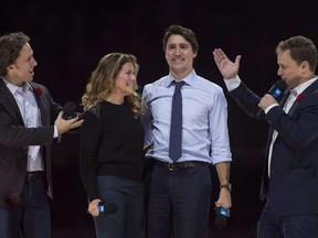 WE Charity co-founders Craig (left) and Marc Kielburger introduce Prime Minister Justin Trudeau and his wife, Sophie Gregoire-Trudeau, as they appear at the WE Day celebrations in Ottawa on November 10, 2015.
