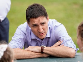 Prime Minister Justin Trudeau speaks with families during a visit in Stratford, P.E.I., July 22, 2022.