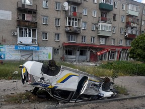A destroyed police car is pictured in the city of Lysychansk on July 12, 2022, amid the ongoing Russian military action in Ukraine.