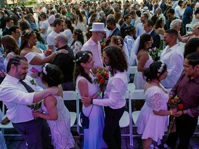 Couples get married during a mass wedding for Covid-delayed couples at Lincoln Center in New York City on July 10, 2022.