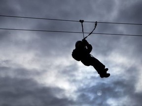 This file image shows a picture of a child ziplining.
