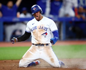 Blue Jays’ George Springer celebrates after scoring a run on a double by Santiago Espinal in the seventh inning against the Baltimore Orioles. VAUGHN RIDLEY/GETTY IMAGES