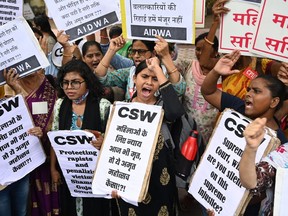 Activists shout slogans and hold placards during a protest against the release, following a recommendation by a Gujarat's state government panel, of men convicted of gang-raping Bilkis Bano during the 2002 communal riots in Gujarat, in New Delhi on August 18, 2022.