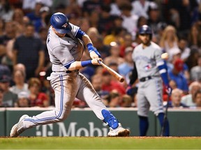 Danny Jansen of the Toronto Blue Jays hits a solo home run in the sixth inning against the Boston Red Sox at Fenway Park on August 25, 2022 in Boston, Massachusetts.
