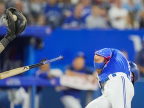 Lourdes Gurriel Jr.  of the Toronto Blue Jays drops his bat after getting hit by a pitch against the Chicago Cubs in the sixth inning at the Rogers Centre on August 31, 2022 in Toronto.