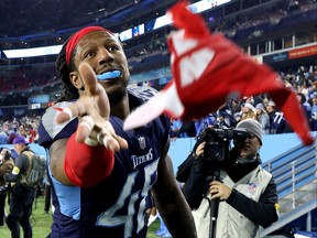 Bud Dupree #48 of the Tennessee Titans tosses his gloves to fans after defeating the San Francisco 49ers at Nissan Stadium on December 23, 2021 in Nashville, Tennessee.