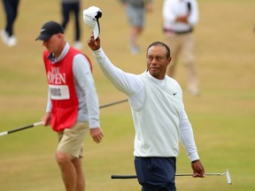 Tiger Woods of the United States acknowledges the crowd on the 18th green during Day Two of The 150th Open at St Andrews Old Course on July 15, 2022 in St Andrews, Scotland.