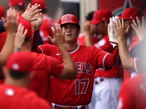 Shohei Ohtani of the Los Angeles Angels celebrates in the dugout after scoring a run in the first inning against the Texas Rangers at Angel Stadium of Anaheim on July 31, 2022 in Anaheim, California.