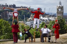 Circus company Lost in Translation show off some tricks at the top of Calton Hill on August 1, 2022 in Edinburgh, Scotland. The Guinness World Record-holding circus company will be performing their fun and acclaimed family show "Hotel Paradiso" at the Circus Hub throughout the Fringe.