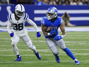 Jermar Jefferson of the Detroit Lions runs with the ball while being defended by Tony Brown of the Indianapolis Colts during the second quarter at Lucas Oil Stadium on August 20, 2022 in Indianapolis, Indiana.